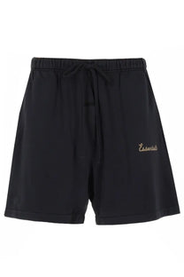 Fear of god essentials men’s black athletic shorts with elastic waistband and gold essentials embroidery for training
