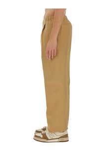 Fendi men’s brown canvas pants with tan wide-leg relaxed fit and elastic waistband front view