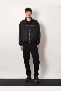 Black fila jacket with gold zipper and trim paired with fendi men’s black cargo nylon trousers