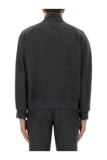 Dark gray wool-blend bomber jacket with subtle textured weave and small embroidered logo on the back by fendi