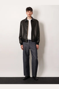 Black leather bomber jacket showcasing premium leather texture paired with Fendi men’s cotton and cashmere white sweater