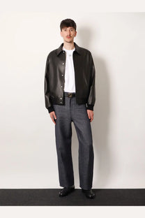 Black leather bomber jacket with classic collar and button closure shown with fendi men’s white cotton shirt