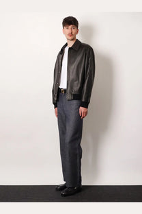 Black leather bomber jacket with ribbed cuffs and collar paired with fendi men cotton and silk blue jeans