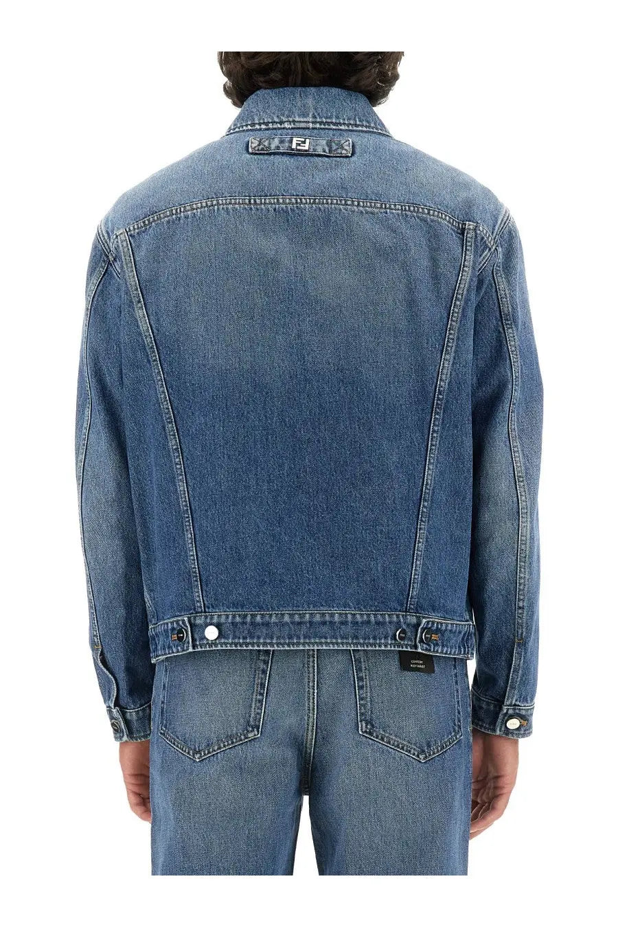 Fendi men’s blue denim jacket with subtle faded wash and contrasting black stitching featuring logo patch on collar