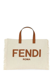 Cream-colored canvas Fendi men’s tote bag with brown leather handles frayed edges and bold fendi roma lettering