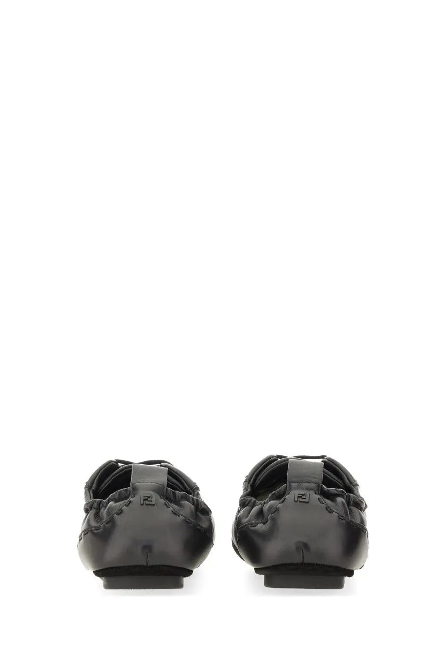 Black leather ballet flats with sleek minimalist design and subtle branding on the heel back side