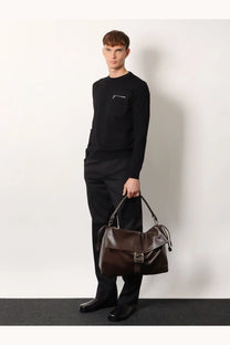 Brown leather duffel bag with metallic buckle and drawstring closure in mens fendi flux maxi messenger style