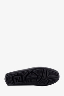 Black rubber sole with embossed fendi logo and geometric patterns on fendi men’s leather and canvas loafers black