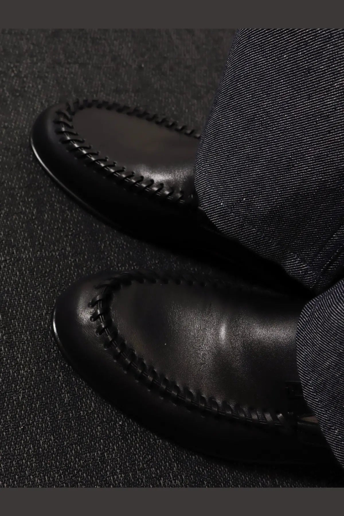 Fendi men’s black leather moccasin loafers with contrasting stitching along the toe for stylish comfort