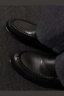 Fendi men’s black leather moccasin loafers with contrasting stitching along the toe for stylish comfort