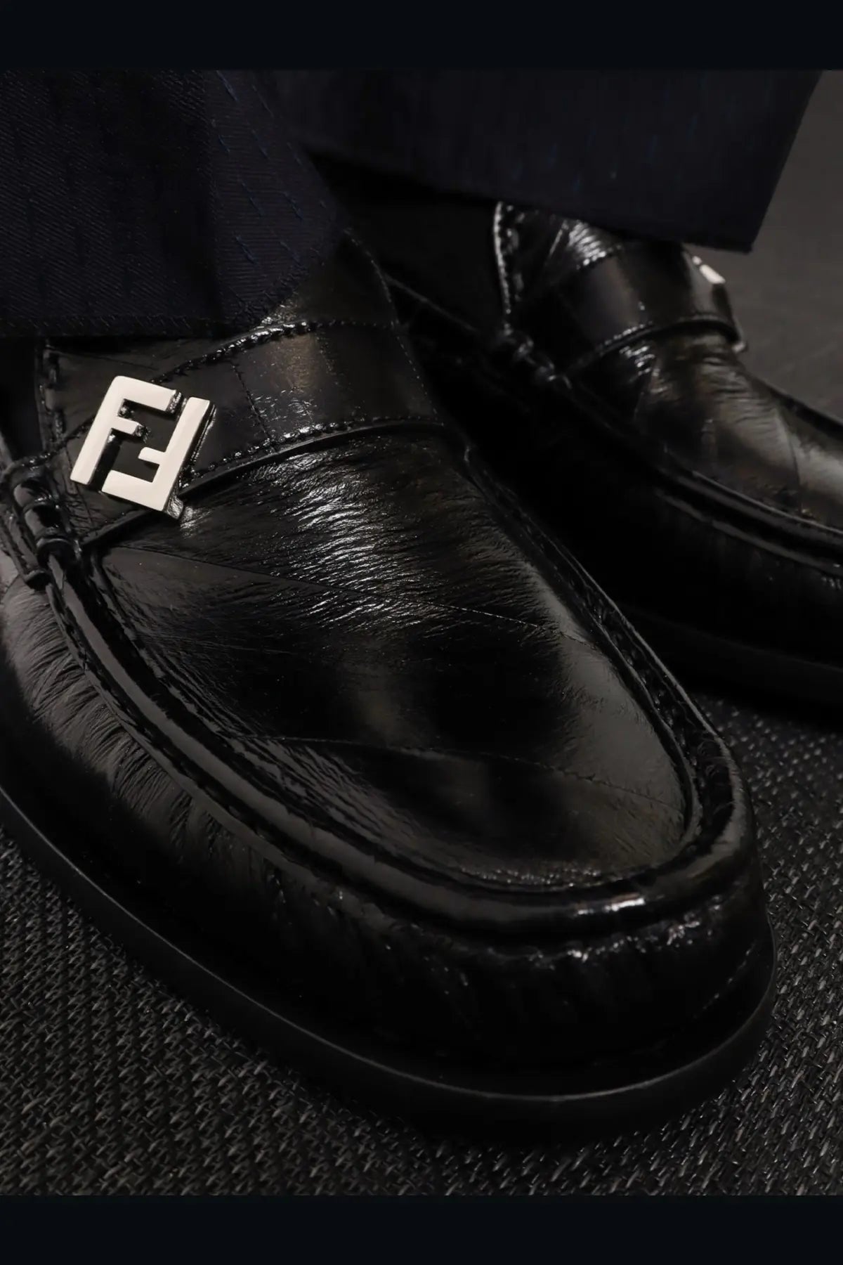 Fendi men’s Missina black leather loafers with black patent leather and prominent silver Fendi logo plaque