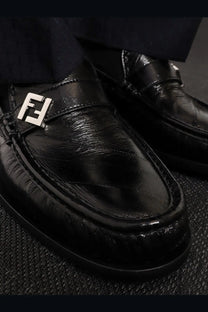 Fendi men’s Missina black leather loafers with black patent leather and prominent silver Fendi logo plaque