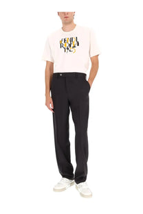 A cream-colored Fendi men’s shirt with bold black and yellow Fendi Roma 1925 lettering across the chest