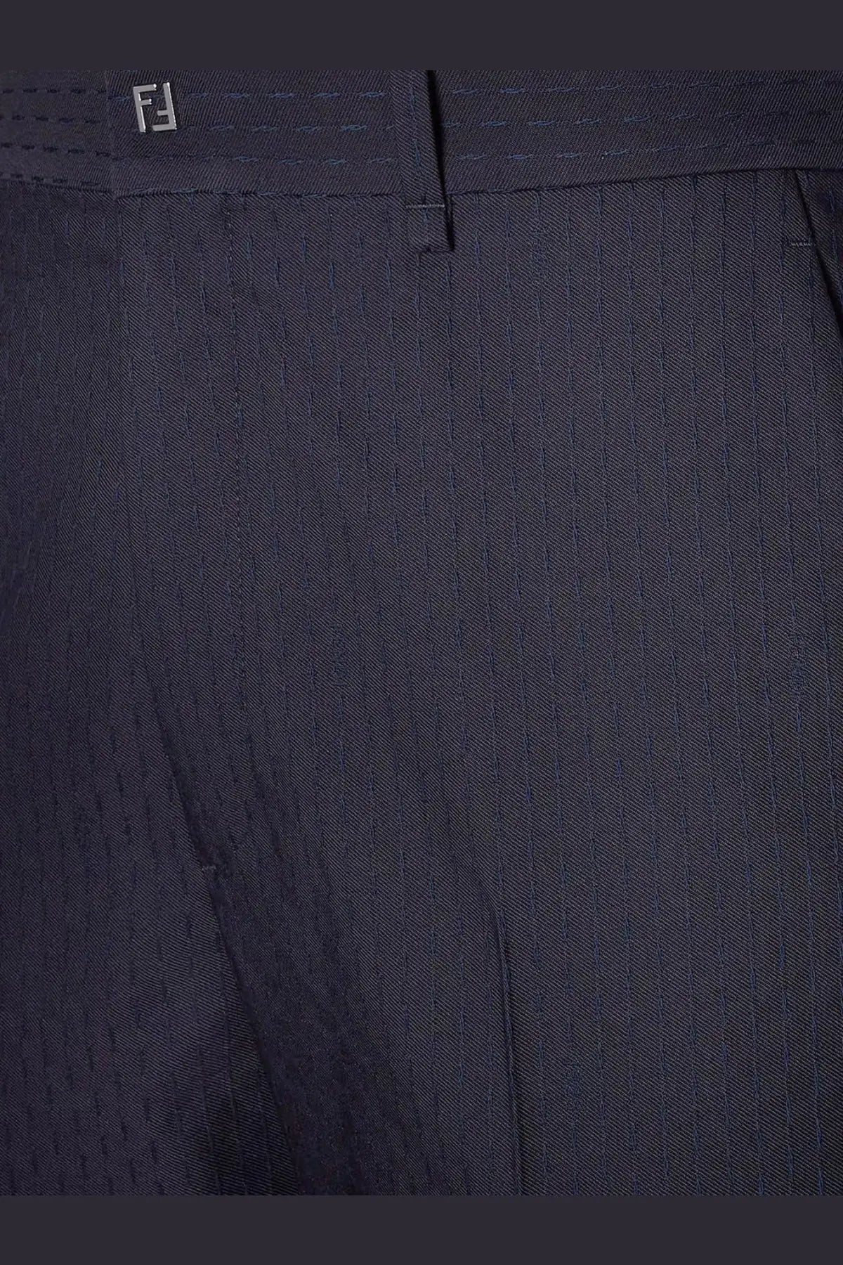 Dark navy wool pinstripe trousers with subtle woven texture and embroidered fendi logo at waistband