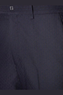 Dark navy wool pinstripe trousers with subtle woven texture and embroidered fendi logo at waistband