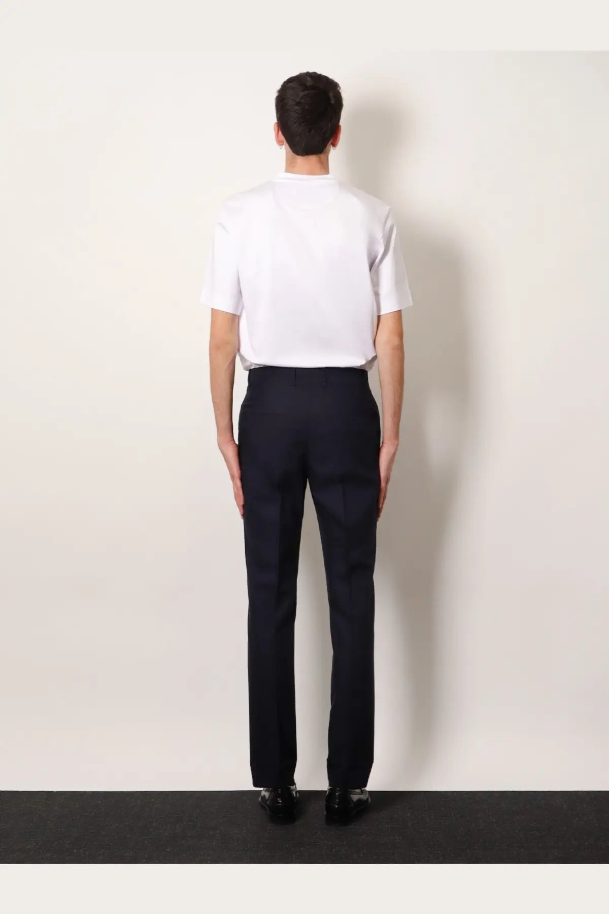 Navy blue tailored wool trousers with tonal stitching for men by Fendi shown from the back side