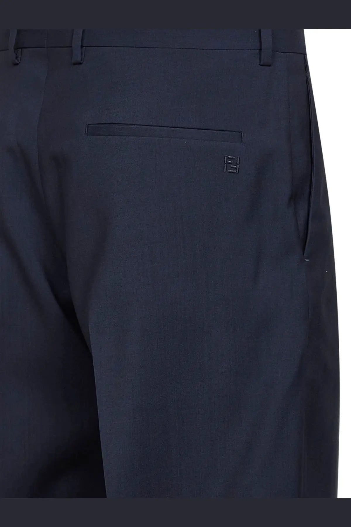 Back side of dark navy blue fendi men’s tailored virgin wool trousers with subtle embroidered logo on back pocket