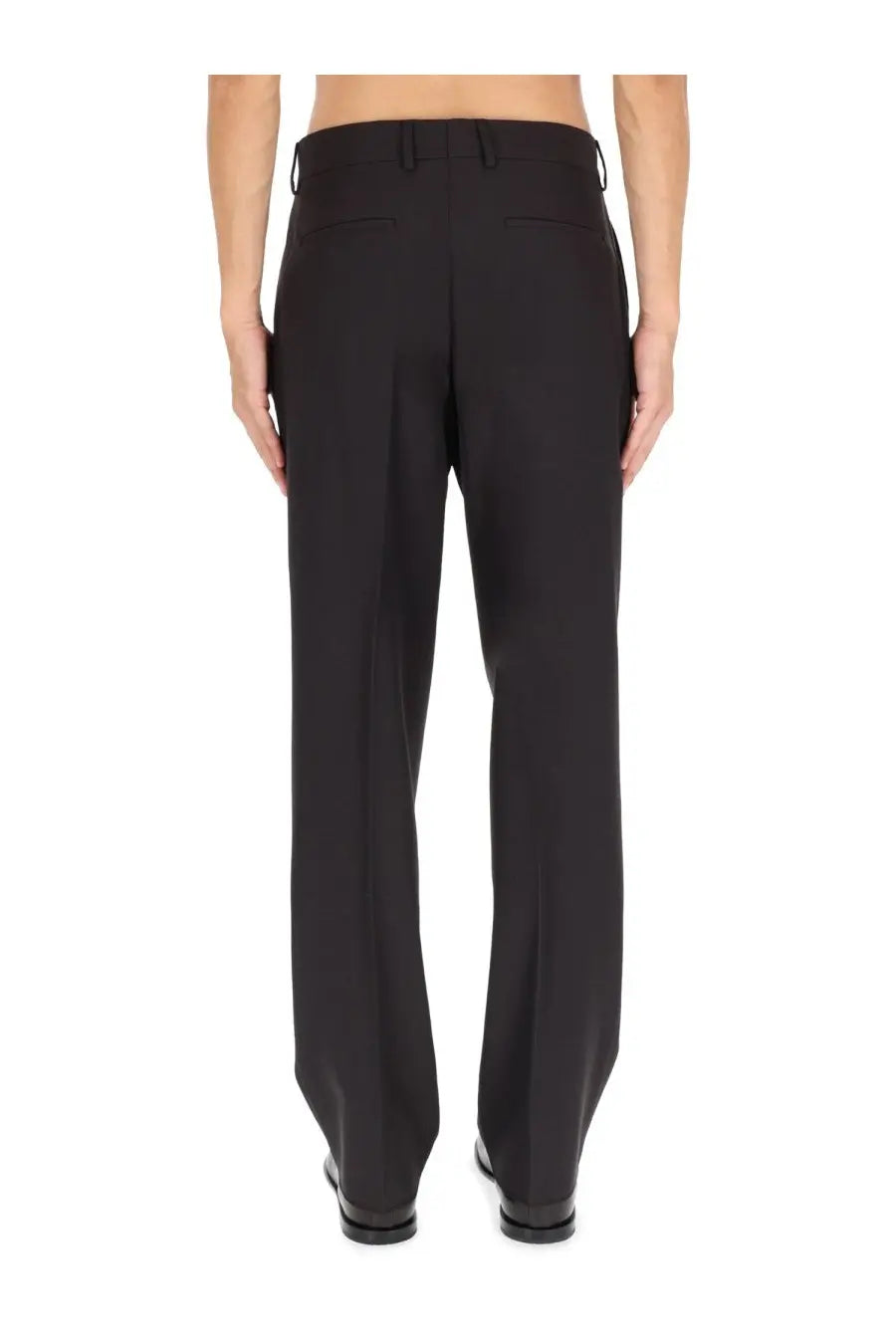 Black tailored wool blend trousers by Fendi with a sleek straight-leg cut and subtle back pleats shown from the back
