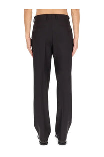 Black tailored wool blend trousers by Fendi with a sleek straight-leg cut and subtle back pleats shown from the back