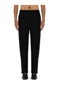 Fendi men’s black wool pants with tailored fit pleats and subtle texture for a sleek formal look