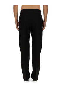 Fendi men’s black wool tailored trousers with sleek straight-leg cut and subtle pleats at the back side