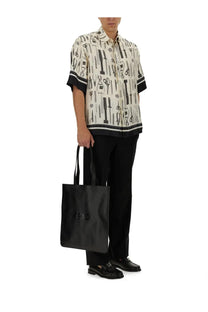 Black fendi tote bag with embossed logo paired with men’s black wool pants for a sleek stylish look