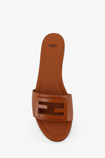 Brown leather fendi baguette slide sandal with a beige rectangular logo buckle for women