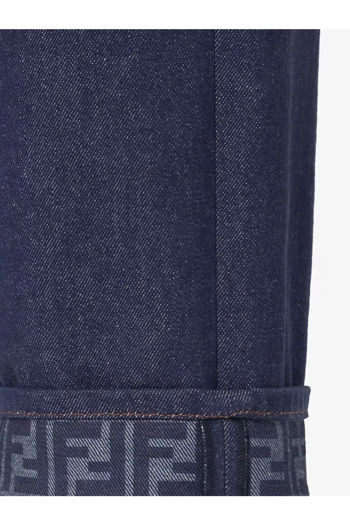 Fendi women’s blue denim jeans featuring dark blue fabric and a repeating logo pattern on the rolled cuff