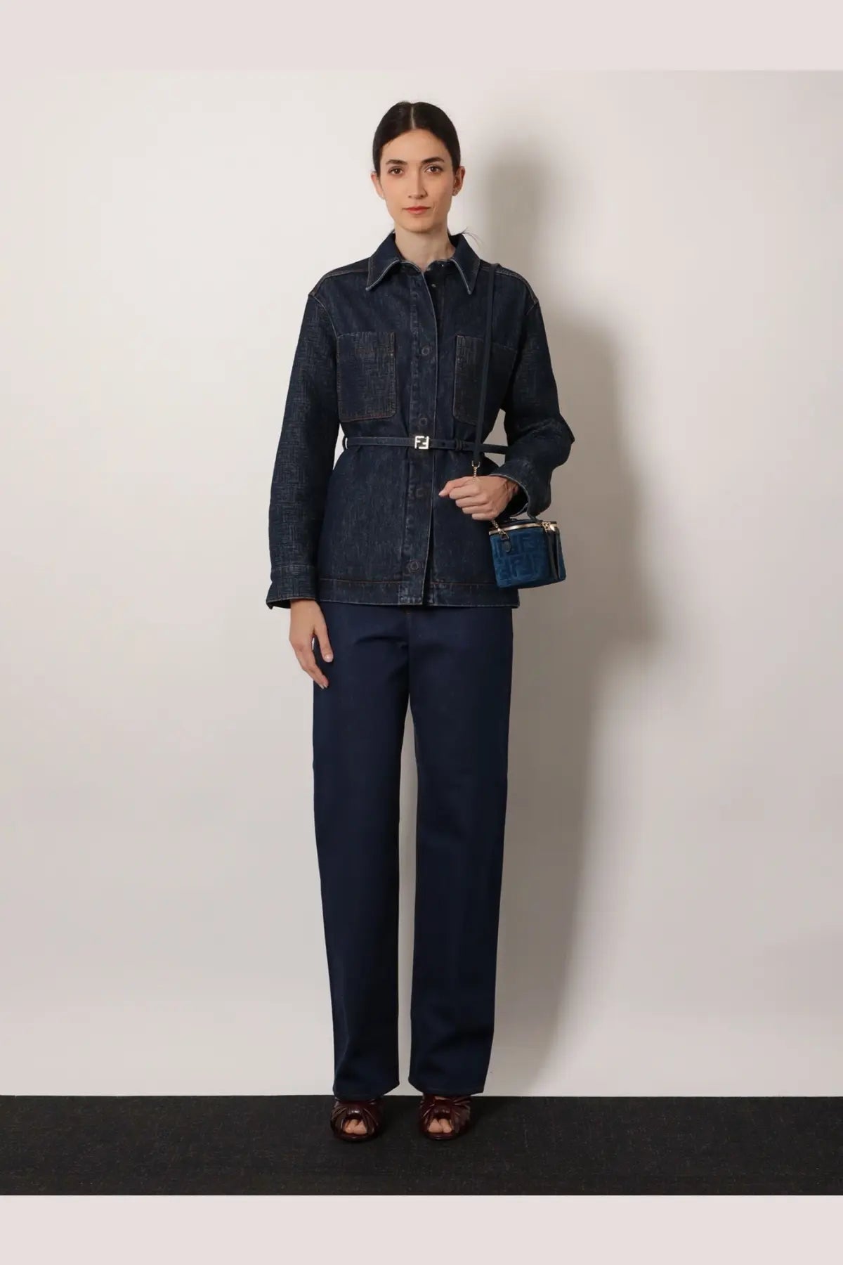 Fendi women’s blue denim jacket with belted waist and front pockets made from dark blue denim material