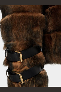 Brown faux fur boot cuff with black leather straps and gold buckles paired with fendi brown sheepskin jacket