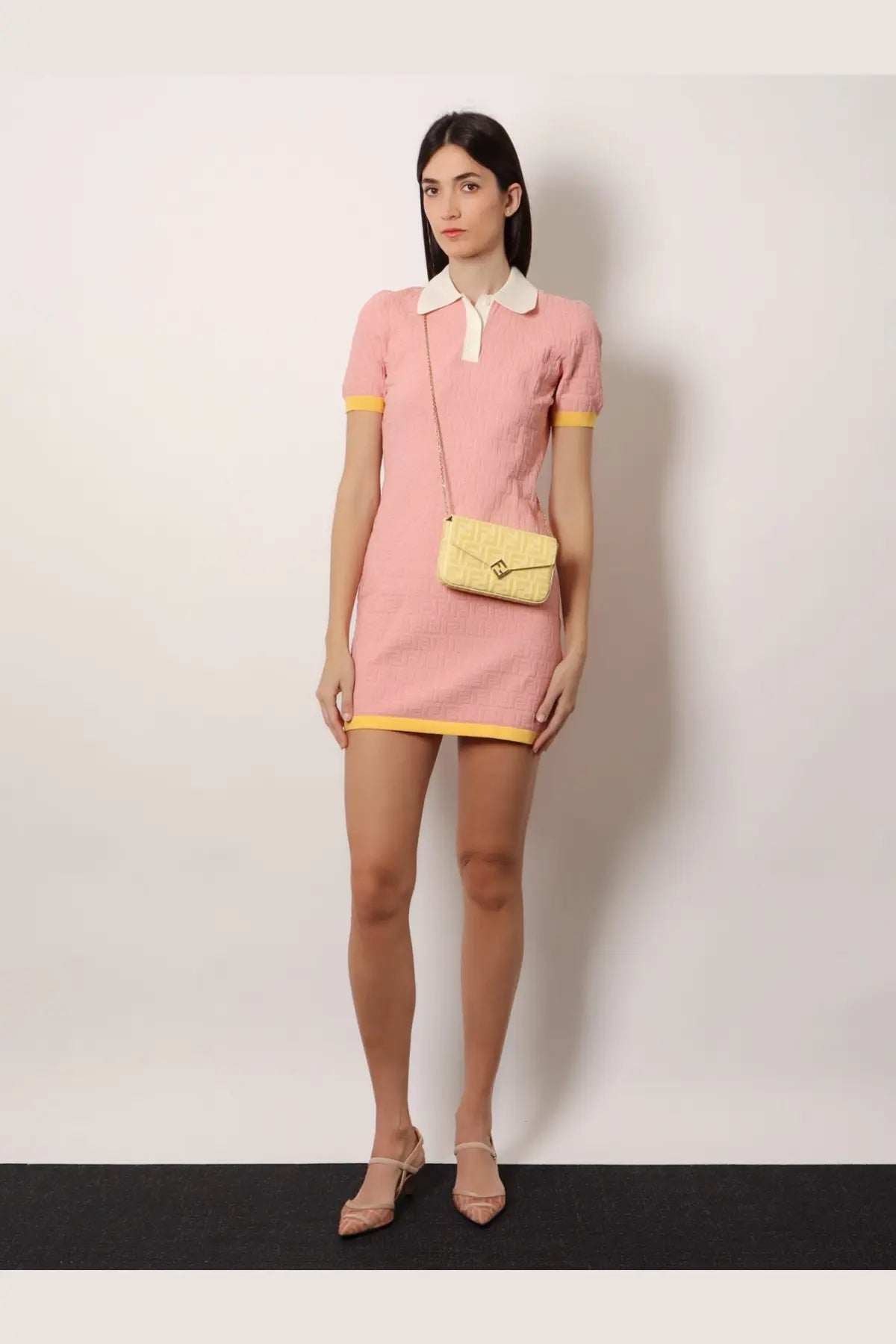 A pale yellow quilted crossbody bag with a gold-tone clasp paired with a fendi women’s cotton and silk blend dress magnolia 26