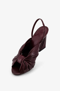 Fendi women’s decolleté arco leather sandal in burgundy with knotted front and slender ankle strap