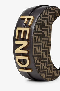 Black leather Fendi belt with gold-tone lettering and brown monogram canvas shown with Fendi women’s Fendigraphy handbag