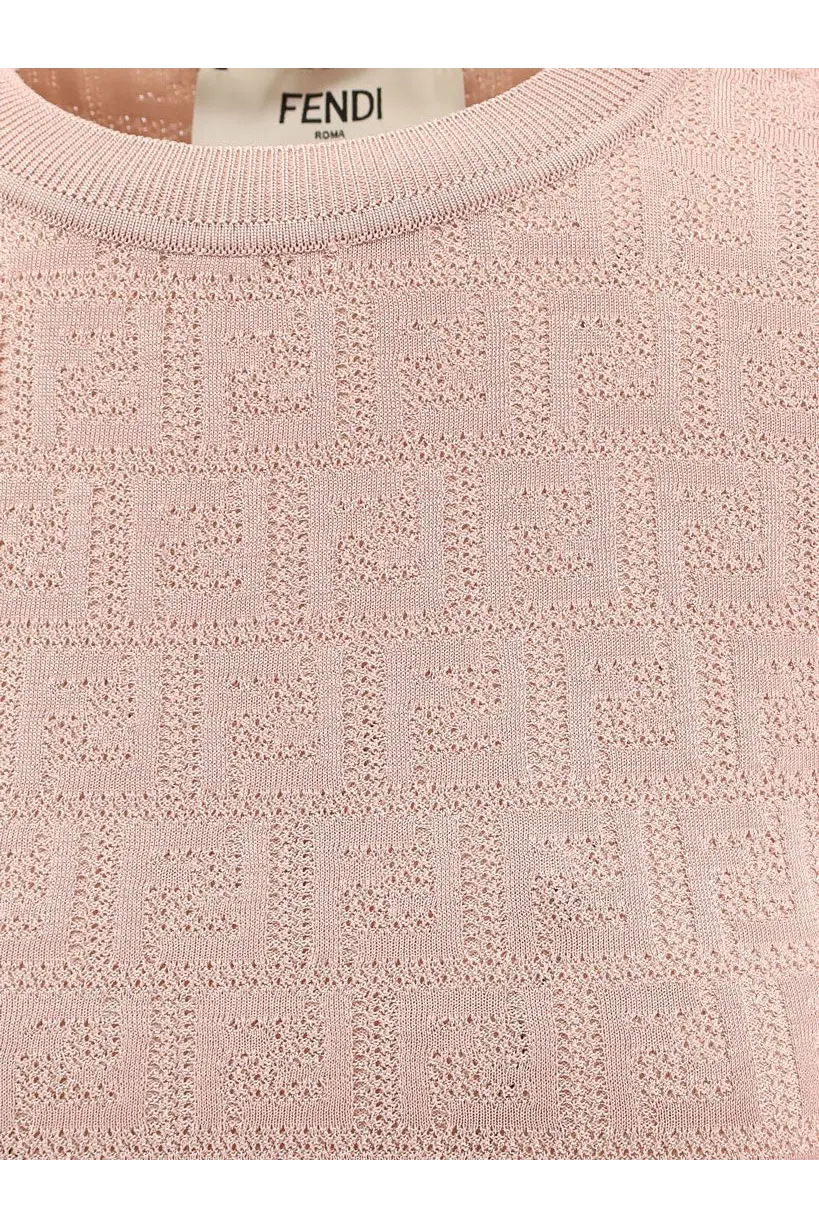 A soft pink fendi sweater with an intricate repeating ff logo pattern woven into cotton and viscose knit fabric
