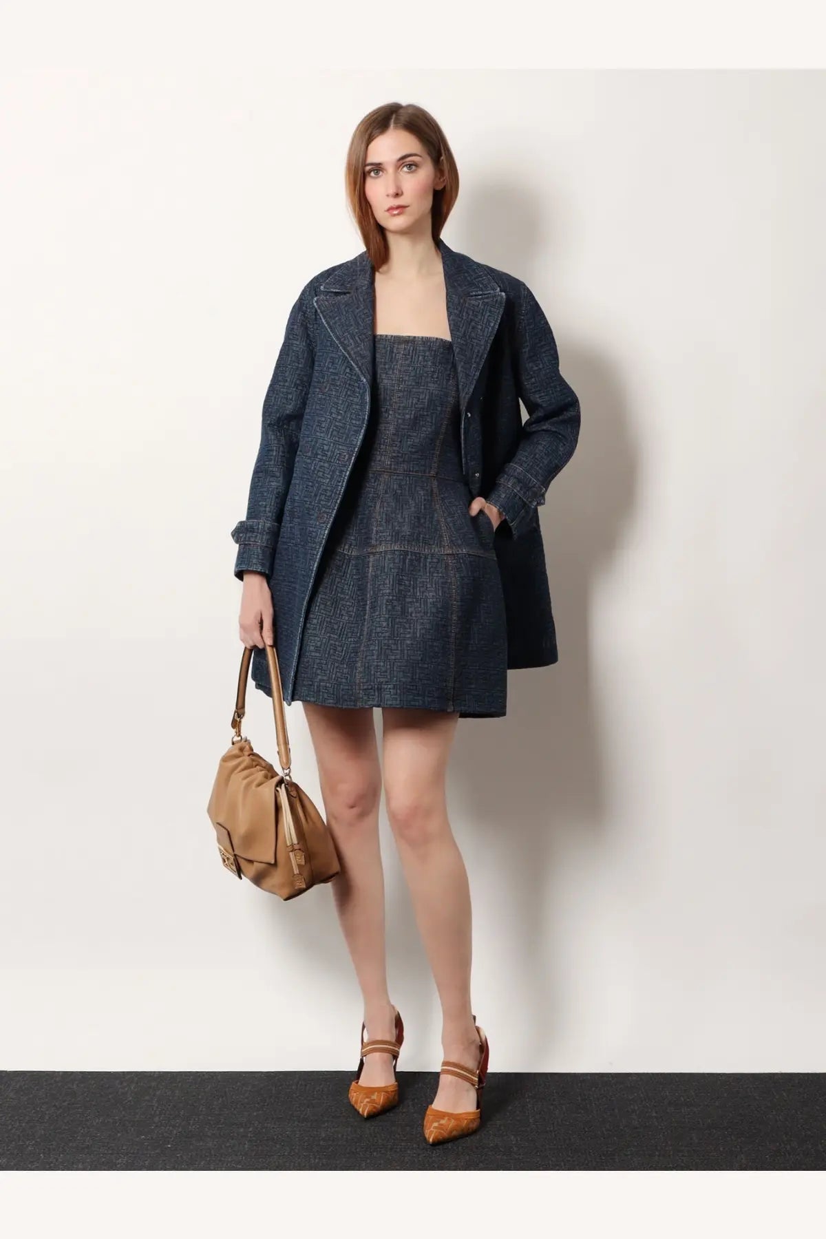 Tan leather shoulder bag with structured minimalist design and top handle paired with fendi womens ff padded denim caban blue