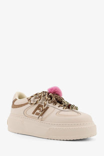 Cream-colored Fendi leather platform sneaker with brown logo detailing and pink pom-pom accent on the laces