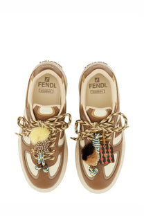Fendi women’s beige match sneaker featuring brown and cream leather with braided laces fluffy pom-poms chunky sole