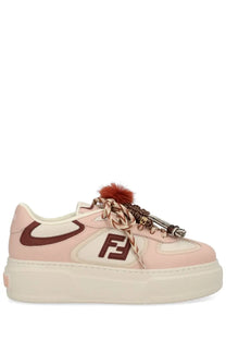 Fendi women’s Fendi Match sneaker in pink with cream sole brown logo accents braided laces and fluffy pom-pom detail