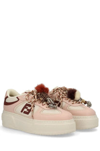 Pink fendi women’s platform match sneaker with cream accents brown logo and decorative fur tipped laces beige model