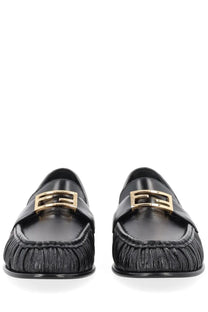 Fendi women’s black leather moccasin loafers with gold-tone rectangular buckles and pleated toe design
