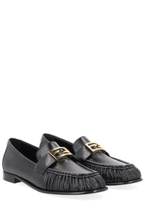 Black leather loafers for women by fendi with gold-tone f-logo buckles and frayed textured toe detail