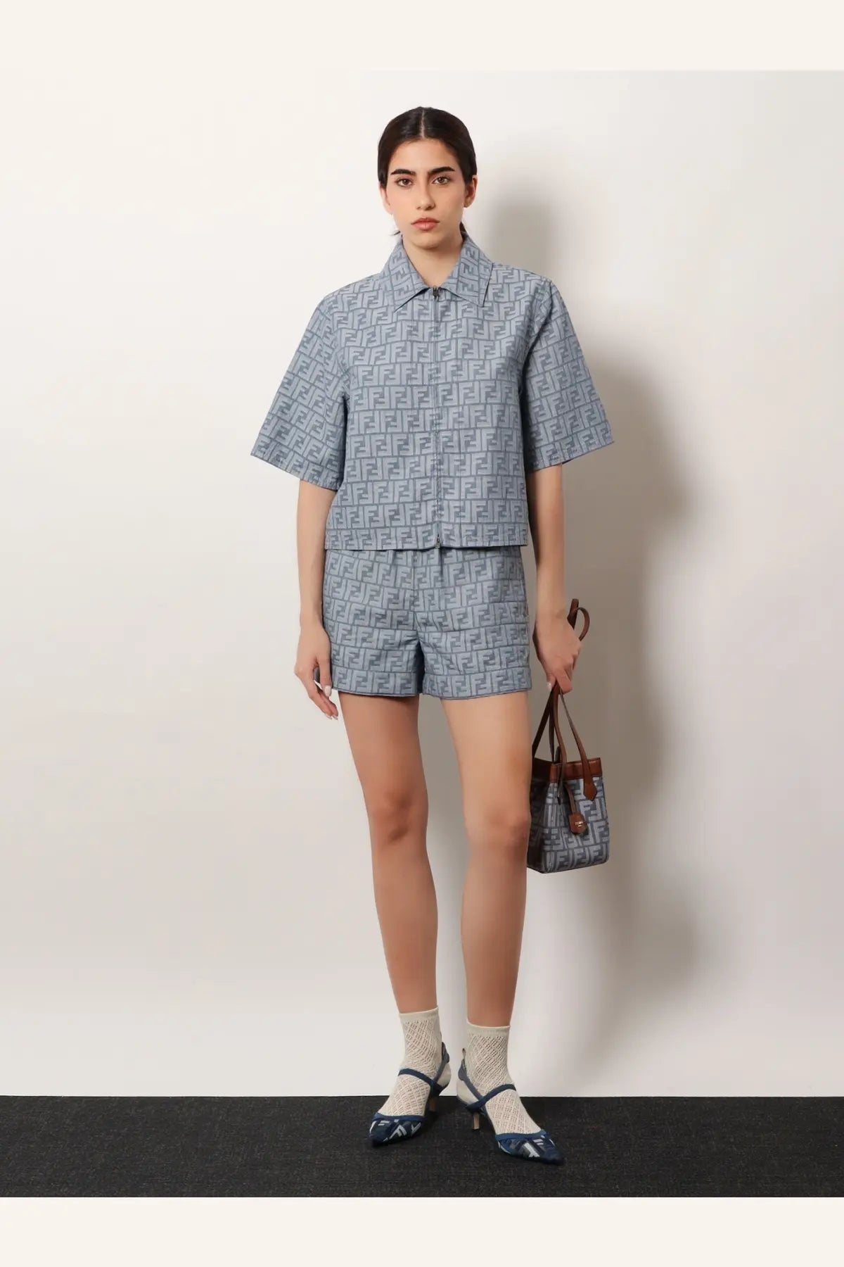 Blue Fendi ff-logo printed short-sleeved shirt and matching shorts set paired with brown leather shoulder bag
