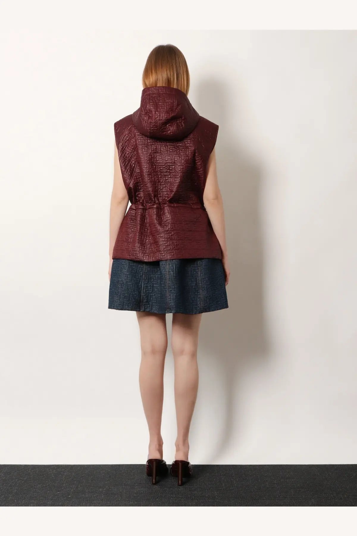 Fendi women’s quilted nylon sleeveless vest in burgundy with hood and cinched waist for stylish layering