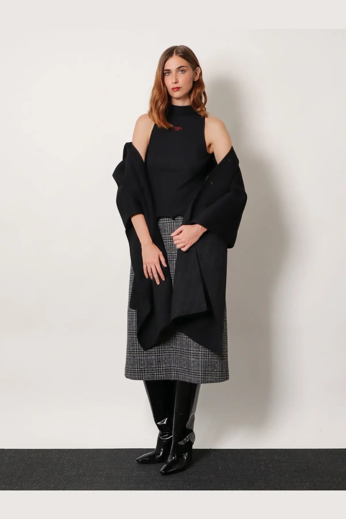 Black off-the-shoulder ribbed virgin wool top with subtle red logo on chest from Fendi womens collection