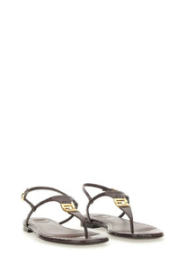 Dark brown leather thong sandals with gold-tone metallic fendi logo accents for women