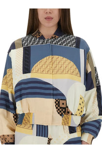 Fendi women’s silk bomber jacket in blue with bold patchwork geometric patterns in navy beige and yellow