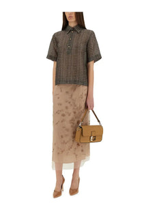 Tan leather fendi handbag with a distinctive rectangular flap and gold-tone hardware matching beige tulle skirt