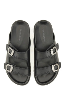 Ferragamo men’s black leather slide sandals with silver metal buckles and cushioned soles showing the insole logo