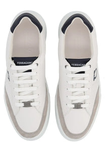 Ferragamo men’s gancini white leather sneakers with navy blue accents and silver metal eyelet detail on the tongue