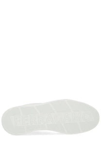 White rubber sole with embossed ferragamo logo on black ferragamo men’s gancini sneaker back side